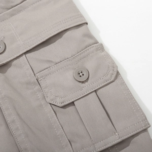 Close-up of multi-pocket cargo pants with button flap and accordion pleat detail