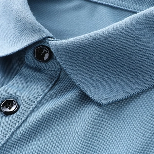 Macro shot of light blue polo shirt collar showing breathable piqué knit fabric detail