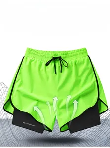 Detail of green athletic shorts with breathable inner liner and elastic drawstring waist