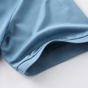 Detail of ribbed cuff and breathable ice silk mesh fabric on dark blue polo shirt