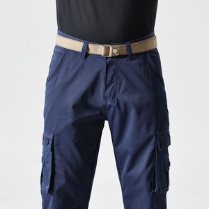 Detail of dark blue cargo pants with side flap pockets and khaki nylon woven belt