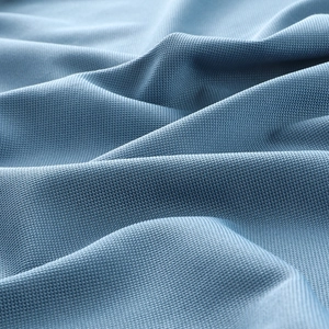 Close-up of blue ice silk polo shirt fabric with breathable honeycomb mesh structure