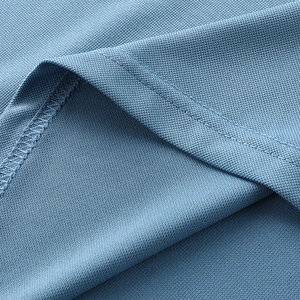 Detail of light blue piqué ice silk fabric showing breathable mesh and double stitching