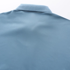 Detailed close-up showing the premium pique texture of a light blue quick-dry polo shirt