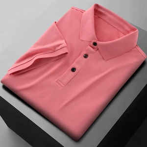 Detail of coral pink polo shirt featuring breathable mesh texture and three dark buttons