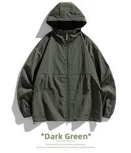 Detailed view of a dark green lightweight hooded windbreaker with water-resistant fabric