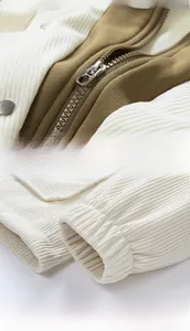 Detail of contrast corduroy jacket with metal zipper and elastic ribbed cuffs