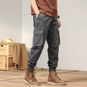 Men's charcoal gray cargo pants with elastic waist and side zippers for outdoor wear