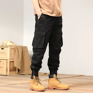 Detail of black cargo jogger pants with side flap pocket and ankle zipper closure