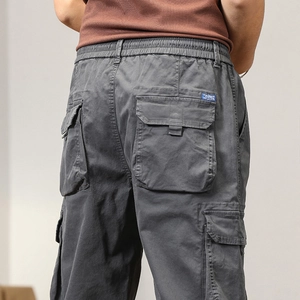 Detail view of cargo pants featuring back flap pockets and elastic waistband with drawstring