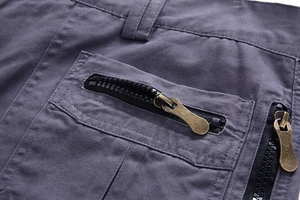 Detail of dark grey cargo shorts showing reinforced zip pockets and twill cotton fabric