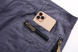 Detail view of cotton cargo shorts showing deep tactical pocket holding a smartphone