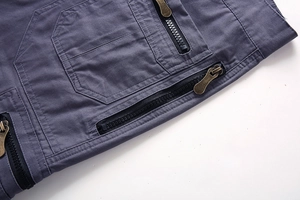 Detailed close-up of multi-pocket cargo shorts with vintage copper zippers and canvas fabric