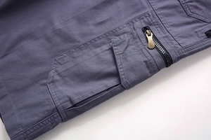Detail of cargo short pockets with zipper and double-stitching on cotton twill fabric