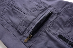 Detail of cargo shorts featuring a bronze metal zipper and durable dark grey twill cotton