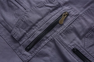 Macro shot of durable cotton cargo pants featuring metal zipper pockets and stitching details