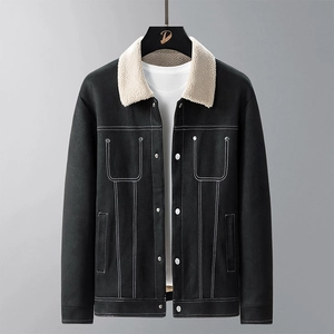 Detail of black winter jacket with beige lamb wool collar and contrast white stitching