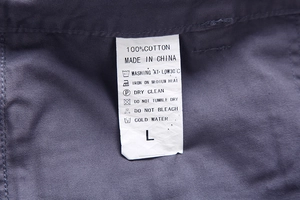 Detail view of the 100% cotton fabric and garment washing label for men's shorts