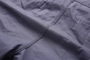 Close-up of double-stitched seams and plain weave cotton fabric on cargo shorts