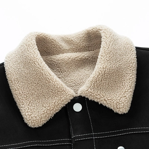 Detail of winter jacket collar featuring beige sherpa lining and contrast white stitching