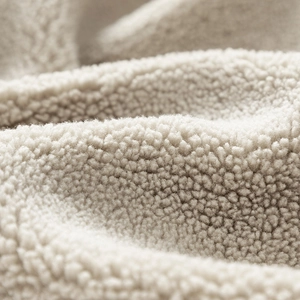 Close-up of premium warm sherpa fleece texture showing thick soft lamb wool fibers