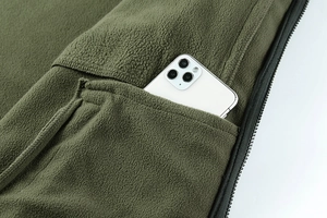 Detail shot of army green fleece jacket with a large side pocket for smartphone storage