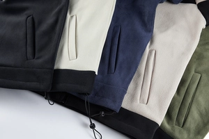 Detail view of fleece jackets in five colors featuring adjustable drawstring hem and pockets