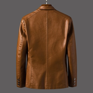 Detail view of the brown leather blazer's back seam and decorative cuff buttons