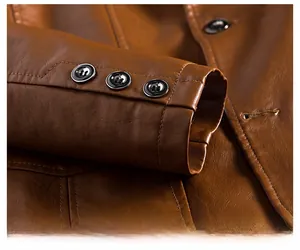 Detailed close-up of warm brown PU leather jacket cuff with three black buttons and stitching
