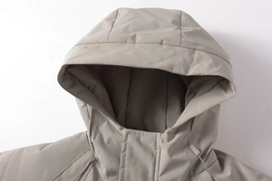 Dettaglio del cappuccio e dello scollo di una giacca outdoor grigia con coulisse regolabili