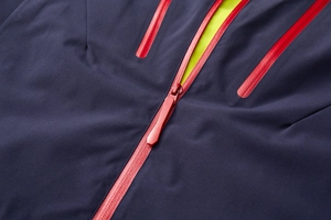 Detail of waterproof taped zippers on a navy blue outdoor functional jacket