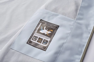 Detail view of the waterproof breathable mesh lining and inner pocket on the blue jacket