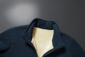 Detail of navy blue fleece jacket with thick cream lamb velvet lining and zipper closure