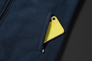 Detail of fleece jacket zipper pocket showing ample depth with a yellow smartphone