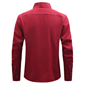 Macro detail of the back yoke and curved hem on this deep red long-sleeved shirt
