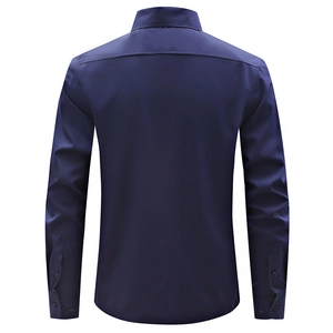 Detail view of the back yoke and cuffs on a dark blue slim fit business shirt for men