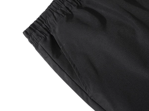 Detailed macro view of elastic waistband and side pocket on men's black sports pants