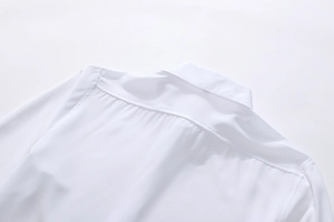 Detailed view of stitching and shoulder seam on a white men's business shirt