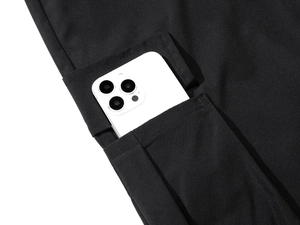 Detail of cargo pocket capacity showing a large smartphone fitting inside the pant pocket