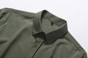 Detailed close-up of the collar and shoulder stitching on a men's olive green dress shirt
