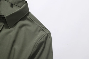 Close-up of military green men shirt featuring reinforced shoulder seams and classic collar