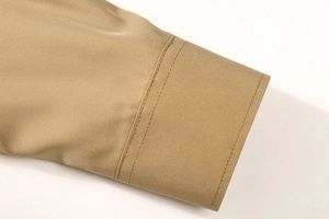 Detail of khaki men's shirt cuff showing premium double-stitched seams and smooth fabric