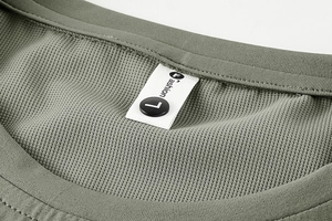 Close-up of army green breathable mesh fabric and collar label on men's sports t-shirt