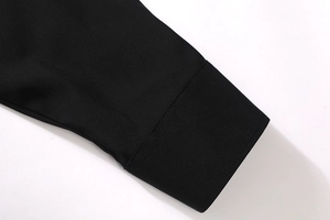 Detailed close-up of a men's black long sleeve shirt cuff with high-quality stitching