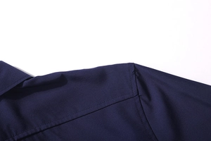 Detail of double-needle stitching on dark blue men's business shirt shoulder