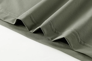 Detail of professional double-needle stitching on the hem of a breathable sports t-shirt