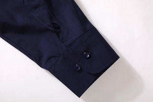 Detail of navy blue long-sleeve shirt cuffs showing neat stitching and double button closure
