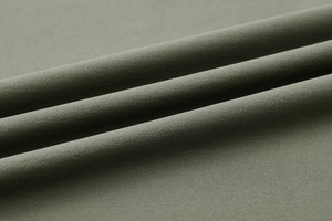 Detailed close-up of olive green breathable fabric texture for sports t-shirt