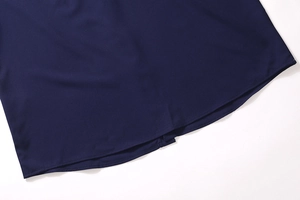 Detailed close-up of navy blue shirt hem with high-quality double-needle stitching