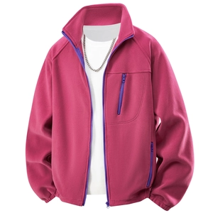 Detail of rose red fleece jacket featuring a purple zipper and thick warm texture